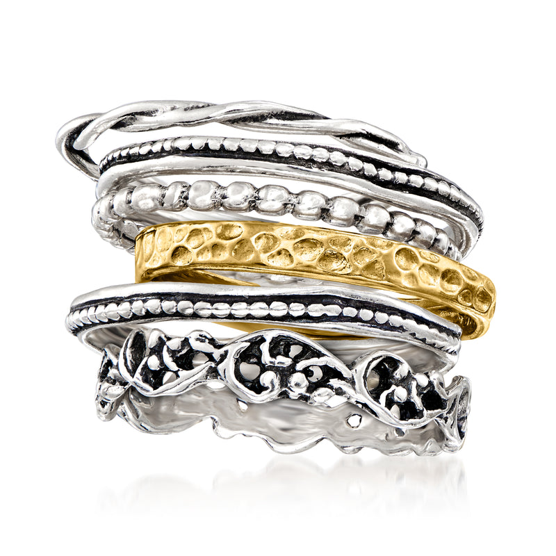 Close-up of textured sterling silver and 18kt gold over sterling stacked rings