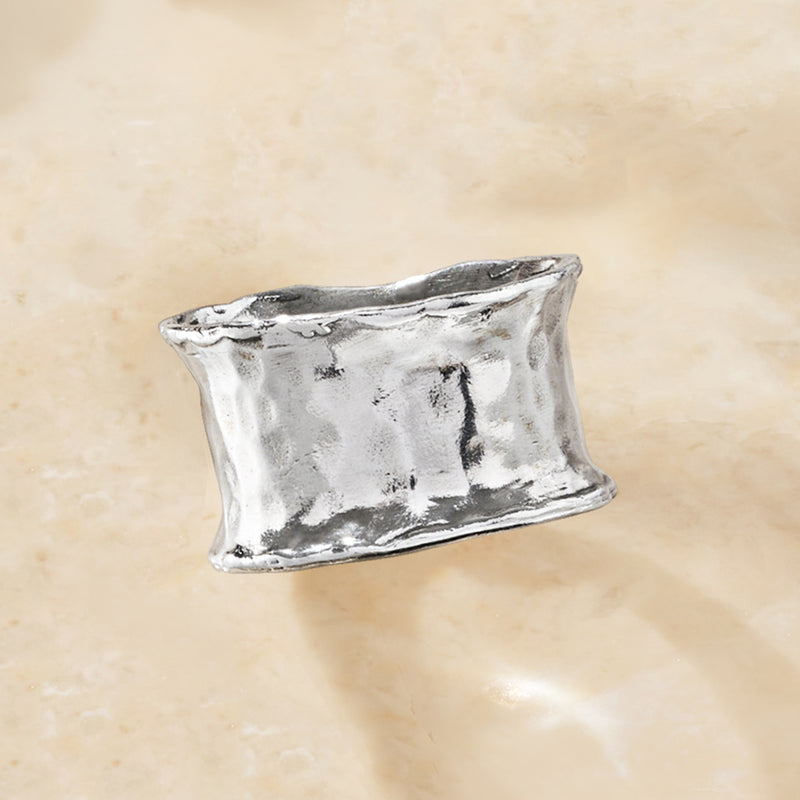 Hammered sterling silver ring with rectangular profile and raised hammered texture.