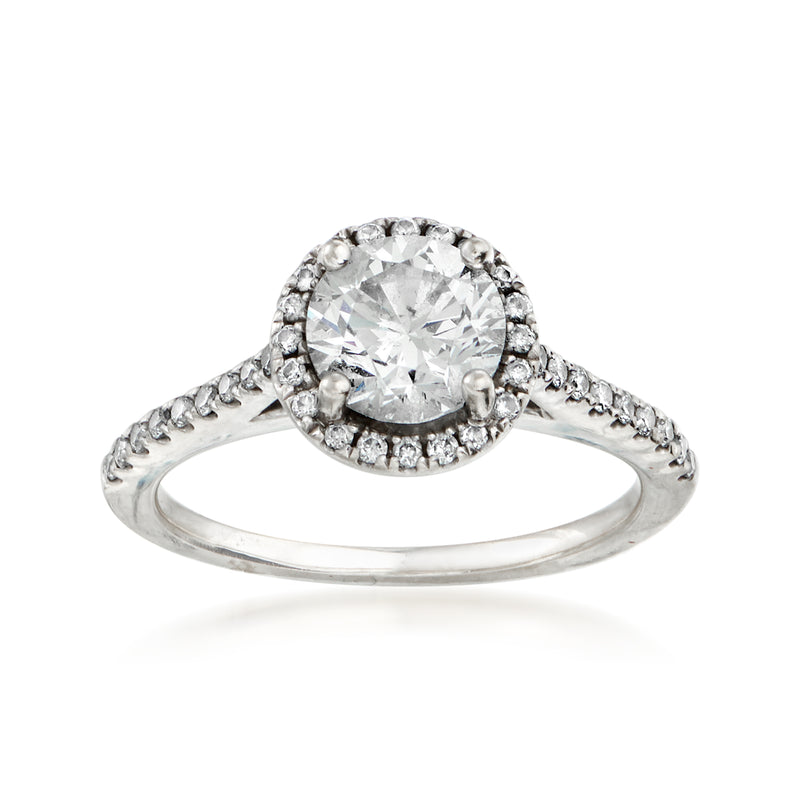 Round diamond halo ring in 18kt white gold with bezel-set center and pave accents
