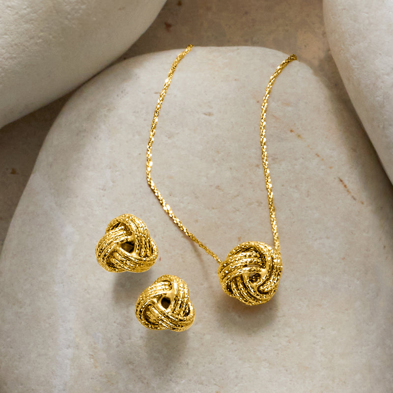Yellow gold love knot necklace and stud earrings set, knot heart charms visible