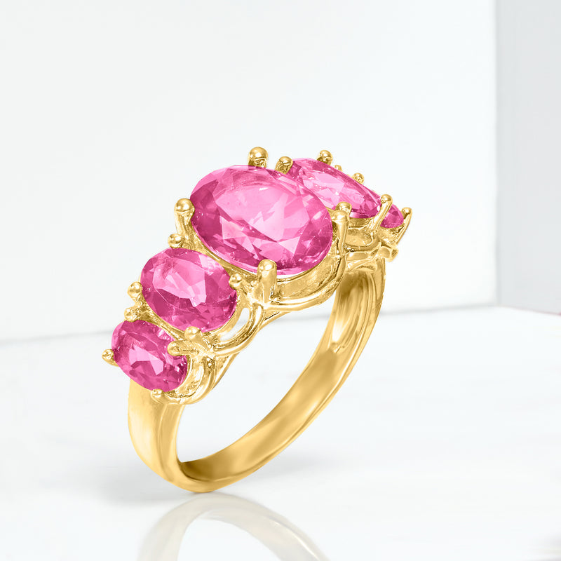 Five-stone pink topaz ring with three rose-pink oval stones and prong settings