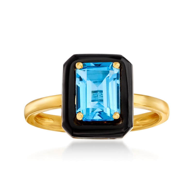 Gold ring with blue rectangular gemstone in black bezel and small gold prongs
