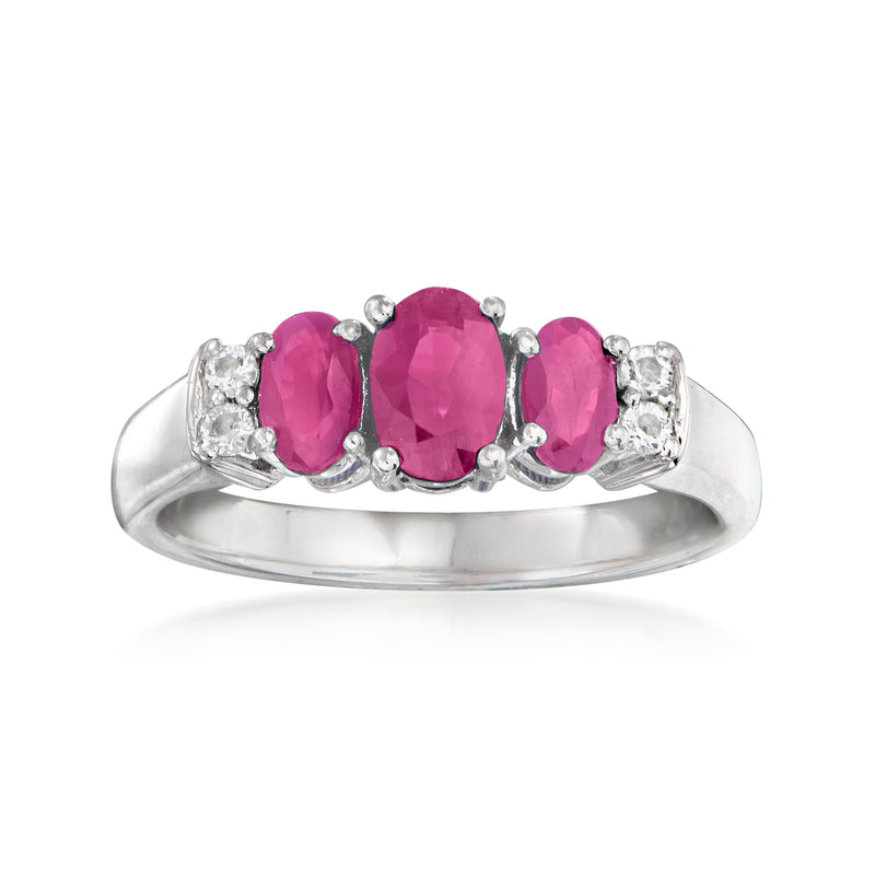 Sterling silver ring with three oval pink ruby gemstones and clear stone accents