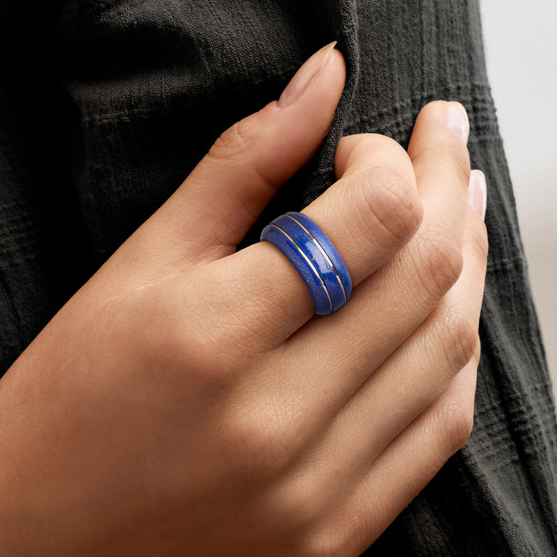 Lapis blue ring with two yellow gold bands on finger