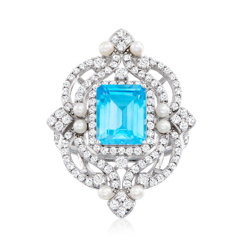 Sterling silver openwork ring with blue topaz center, white stones, and cultured pearls
