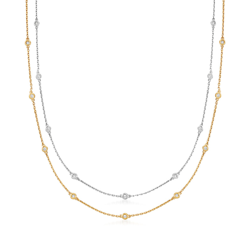 Two-station diamond necklace set with layered gold and silver chains, small round stations