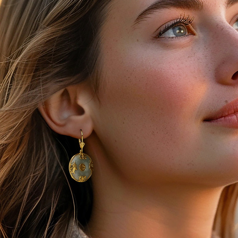 Gold-and-jade drop earrings with round motifs and butterfly charm, leverback style