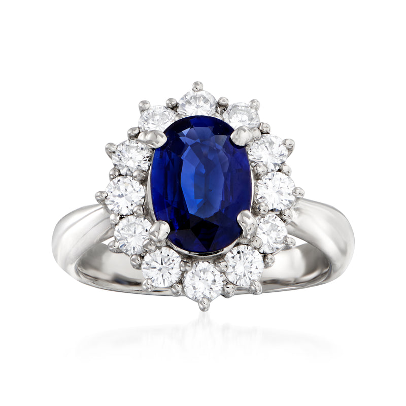 Platinum ring with oval blue sapphire center and diamond halo with round side stones