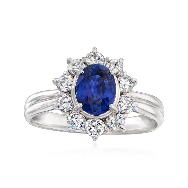 Platinum ring with oval blue sapphire center and round diamond halo, polished band