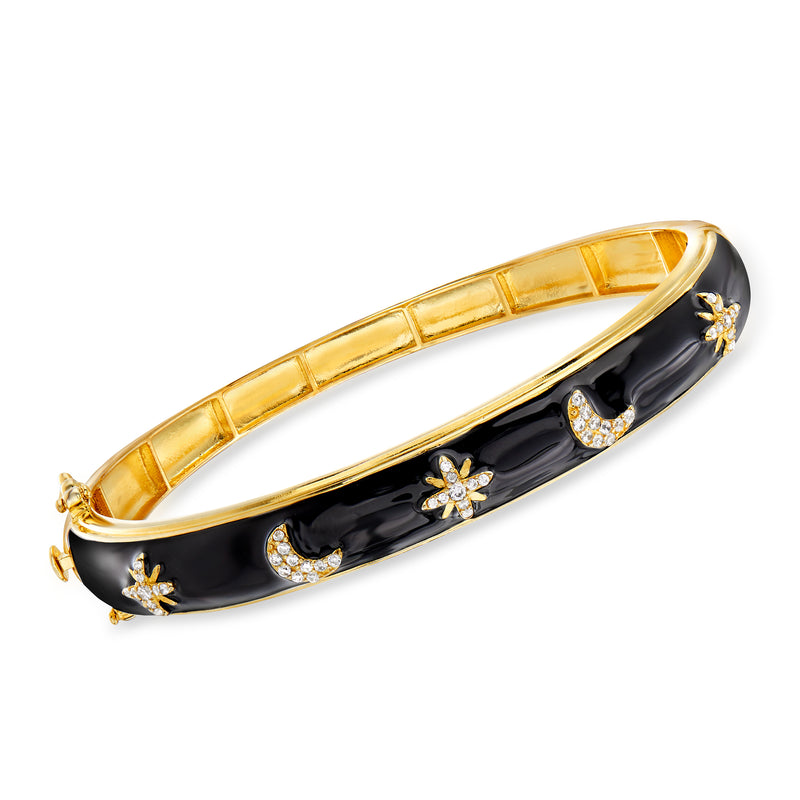 Gold-tone celestial bangle bracelet with black enamel and sparkling star and moon accents