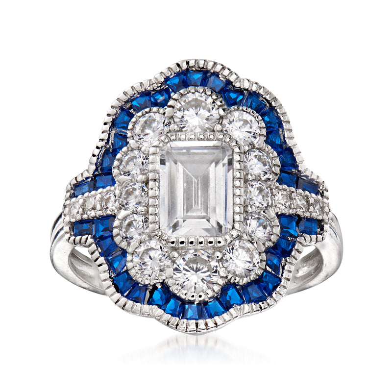 Sterling silver ring with clear CZ center, blue halo stones, and square-cut bezel