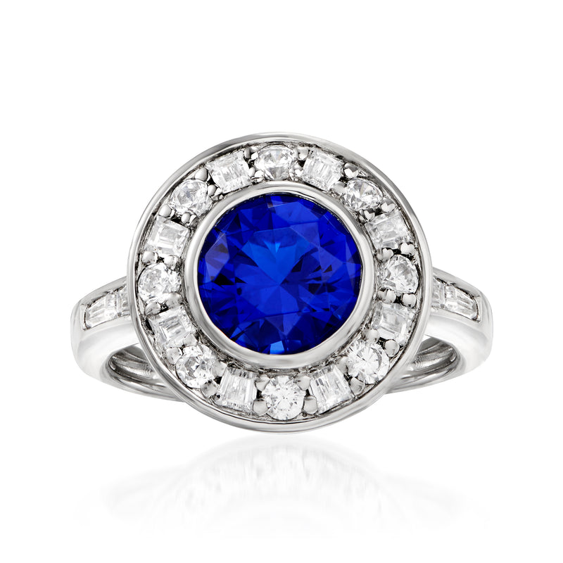 Sterling silver halo ring with blue simulated sapphire center and CZ accents