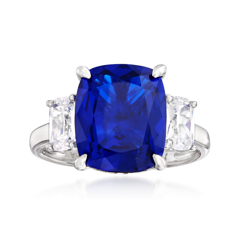 Sterling silver three-stone ring with cushion-cut blue center and clear side stones