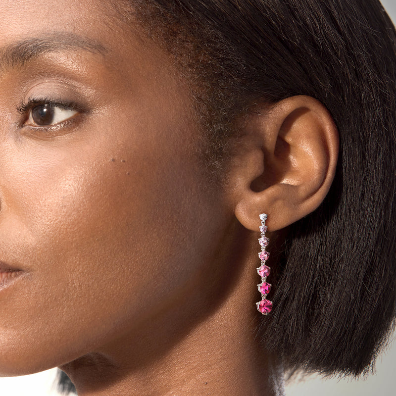 Sterling silver drop earrings on ear, long pink round-stone dangles with clear studs