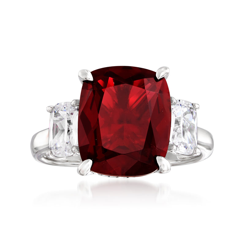 Three-stone sterling silver ring with cushion-cut deep red center and two clear side stones