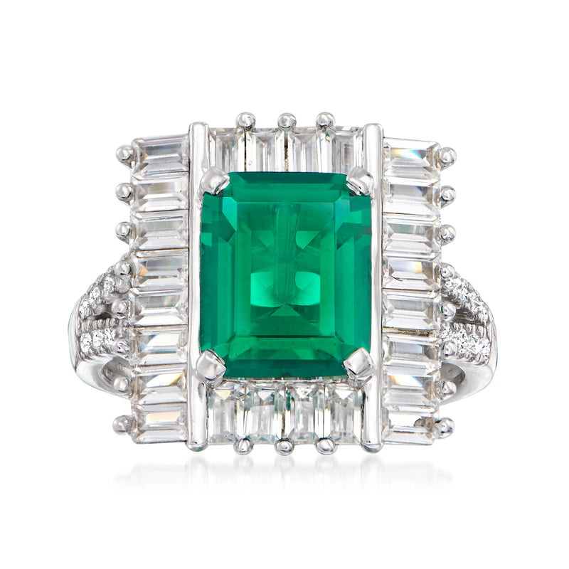 Sterling silver ring with emerald-cut green simulated emerald center and CZ baguette halo