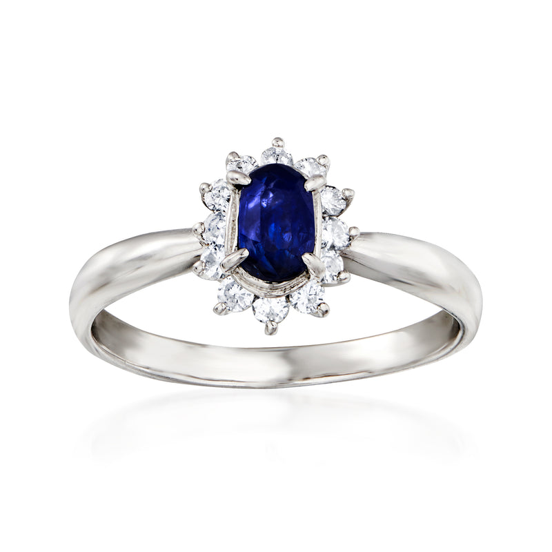 Platinum sapphire and diamond ring with oval blue center stone and halo setting