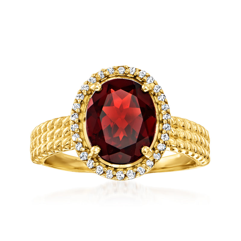 14kt yellow gold ring with oval dark red garnet center, diamond halo, twisted band