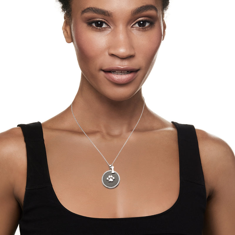 Sterling silver paw print pendant necklace worn on neckline, round black onyx with crystals