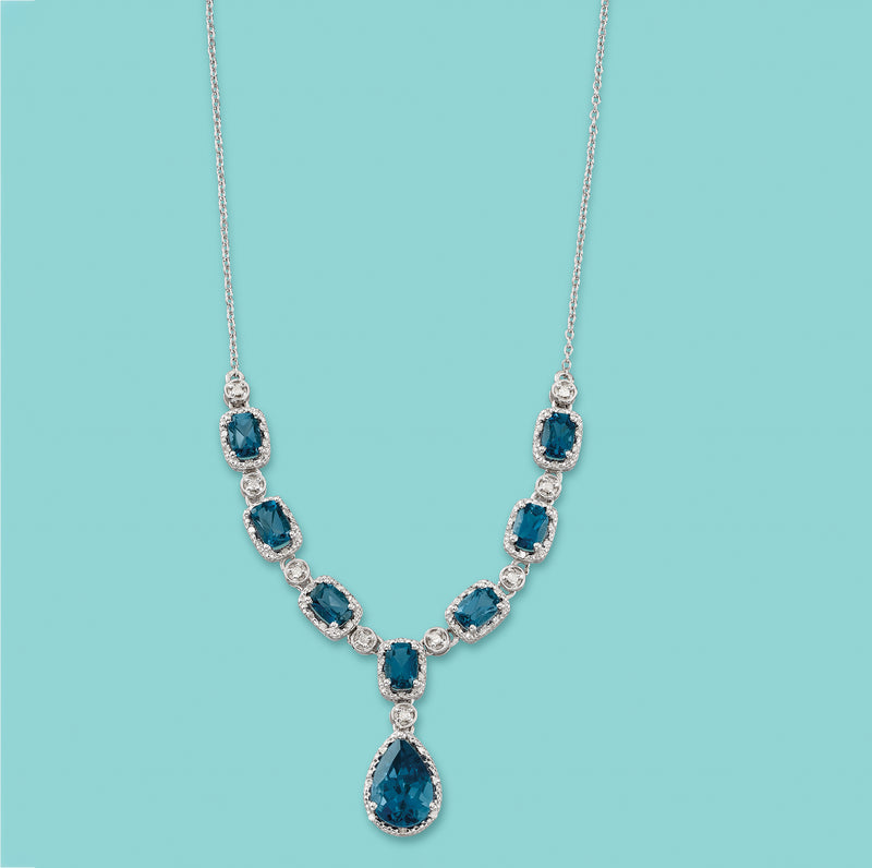 Sterling silver necklace with blue topaz stations and pear drop pendant, full view