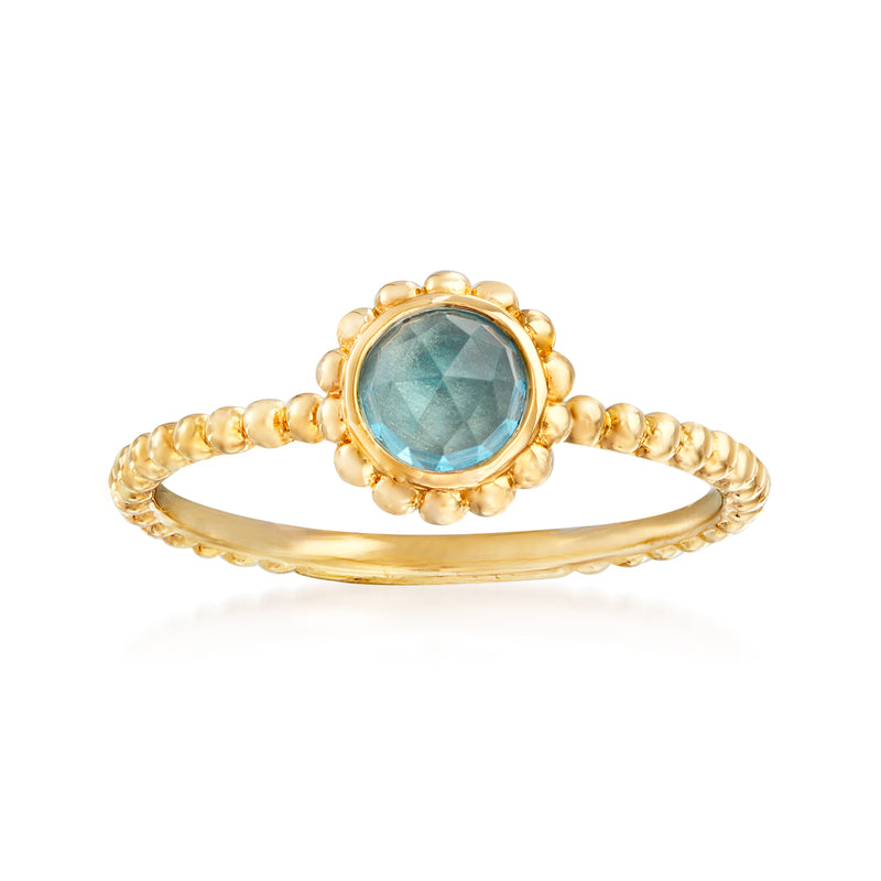 14kt yellow gold ring with oval Swiss blue topaz and beaded halo