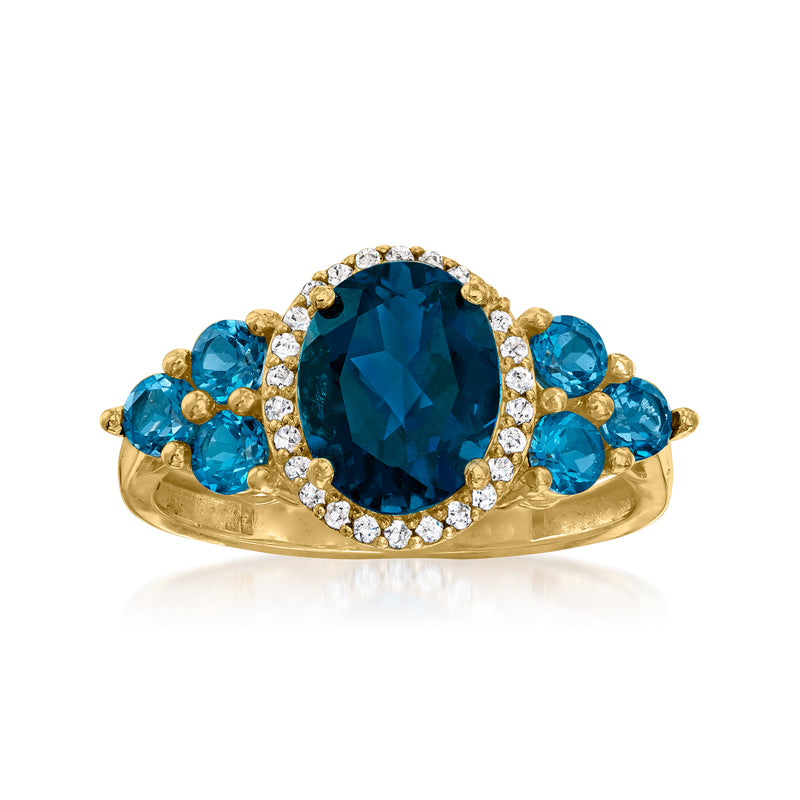 14kt yellow gold ring: oval London blue topaz center, blue stones, white accents