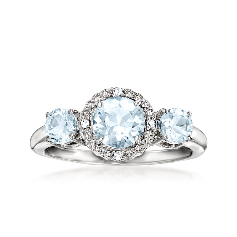 Aquamarine oval ring in 14kt white gold with diamond halo and two side stones