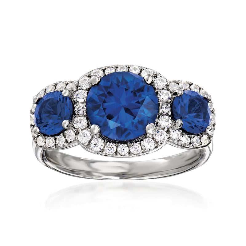Sterling silver three-stone ring with oval blue center stone and round CZ accents