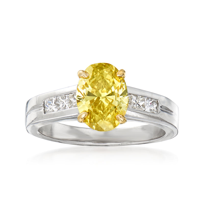 Yellow diamond engagement ring with large round yellow center and white diamond side baguettes