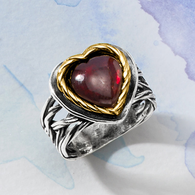 Sterling silver heart ring with garnet centerpiece and yellow gold bezel