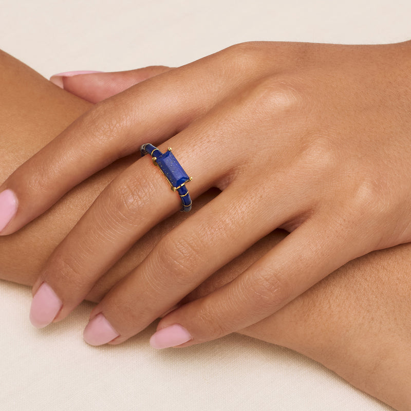 Ring on finger: gold over sterling with rectangular blue stone and dark blue enamel accents