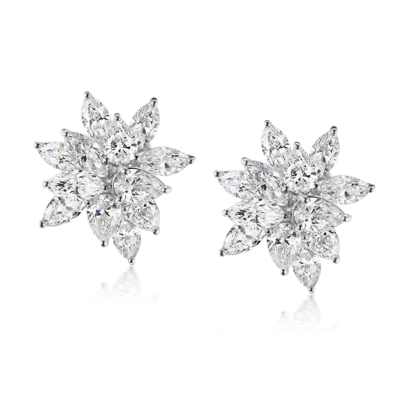 Diamond floral stud earrings with round stones in 18kt white gold, post backs.