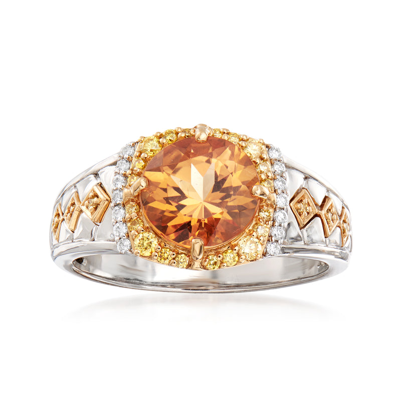 Two-tone gold ring with oval orange topaz center, diamond halo and side accents