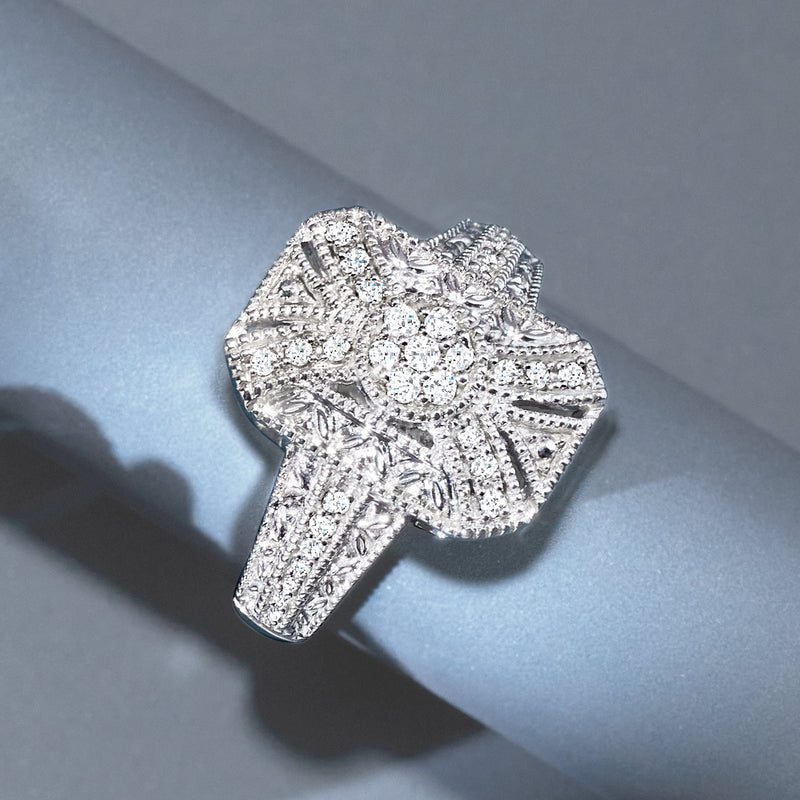Sterling silver diamond scroll ring with round center stones on finger