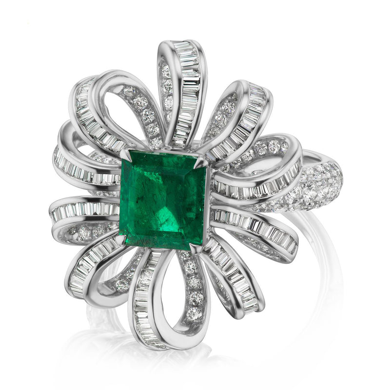 Emerald-cut green gemstone and diamond halo ring in 18k white gold