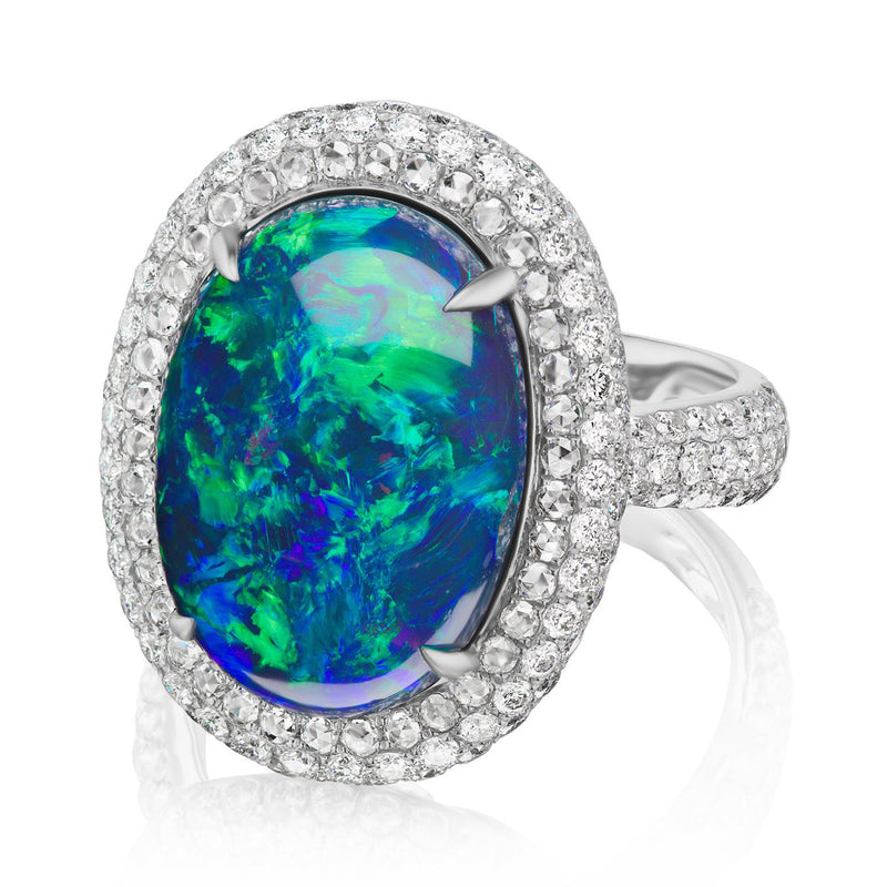 Oval blue-green opal halo ring in 18kt white gold with round diamond border