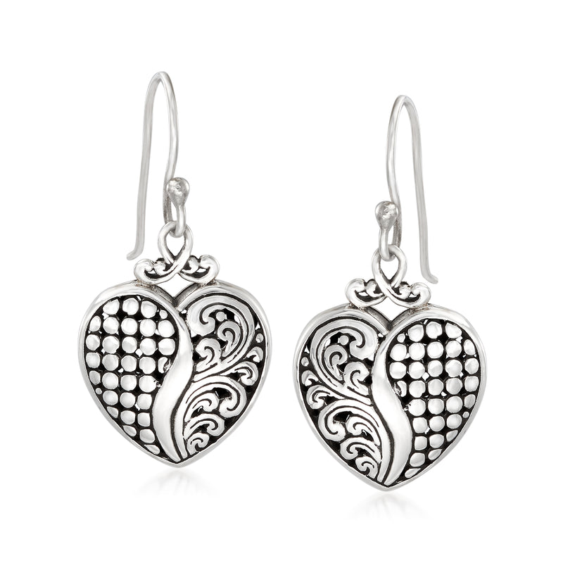 Sterling silver heart drop earrings with textured dot pattern and carved swirl details