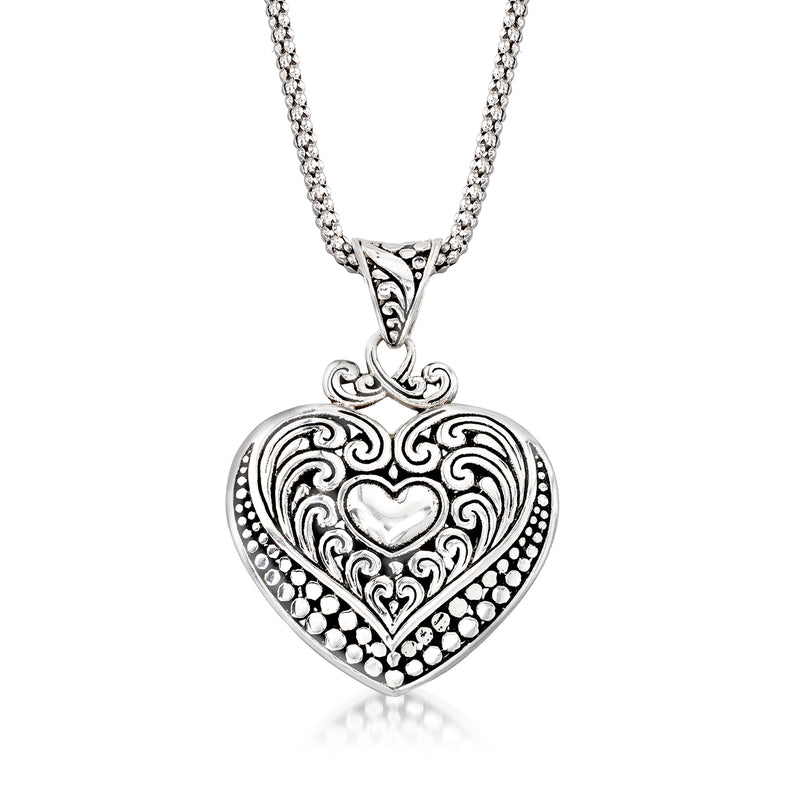 Sterling silver heart pendant necklace with swirl heart design and bead border