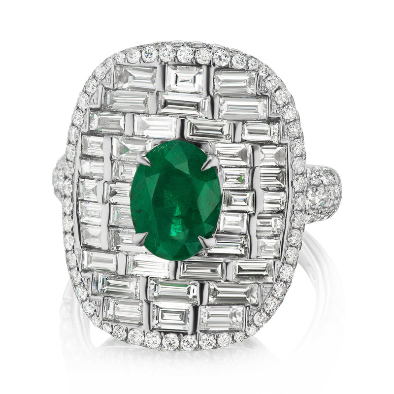Emerald and diamond halo ring in 18k white gold with oval green center stone