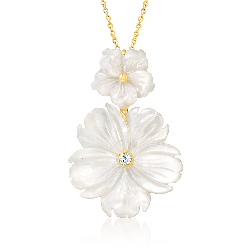 Gold pendant necklace with two white mother-of-pearl flower charms and center white stones