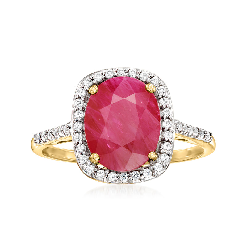 14kt yellow gold ring with oval pink ruby center and white topaz halo