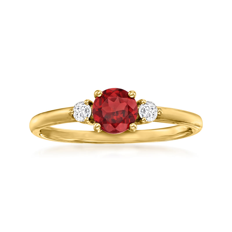 14kt yellow gold ring with oval red garnet center and two round diamond side stones