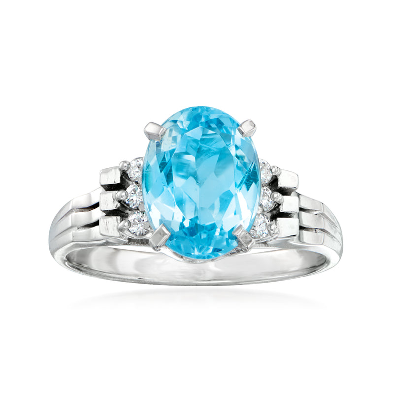 Platinum aquamarine oval ring with diamond accents, prong-set halo