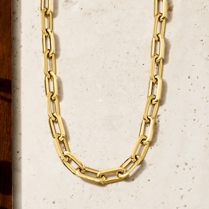 Italian 18kt yellow gold paper clip link necklace laid out with bar and oval links
