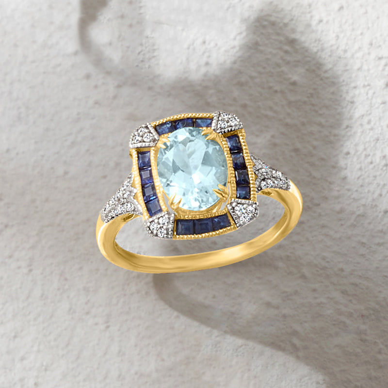 Aquamarine ring in yellow gold with blue sapphire borders and diamond accents