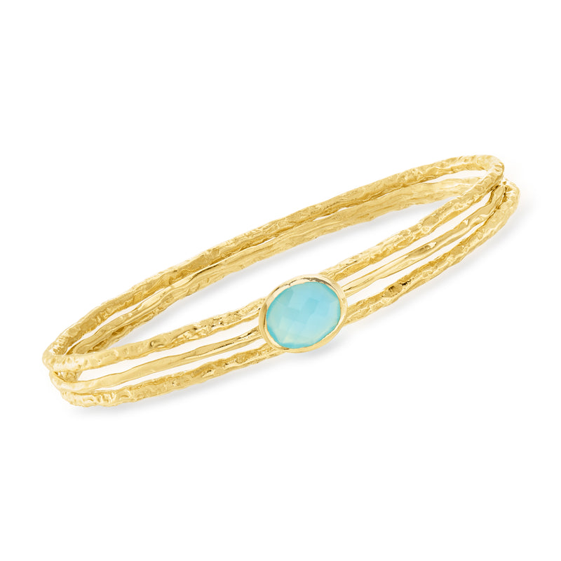 Three gold tone bangle bracelets with oval blue gemstone in center