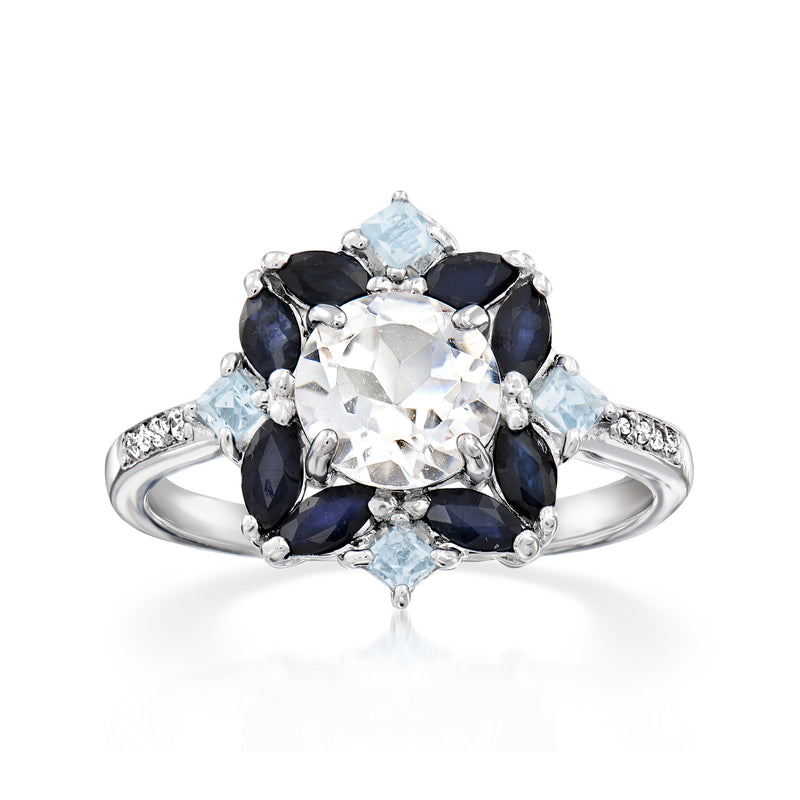 Sterling silver ring with oval white center stone, blue topaz and navy sapphire accents