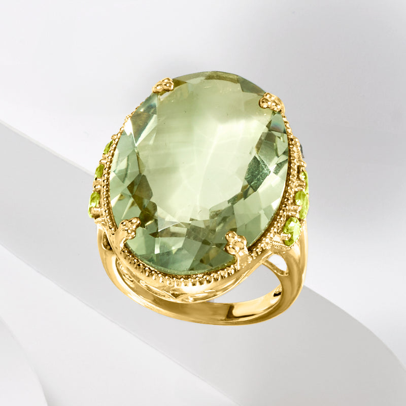 Gold ring with large oval pale-green prasiolite, prong-set, halo with small green stones
