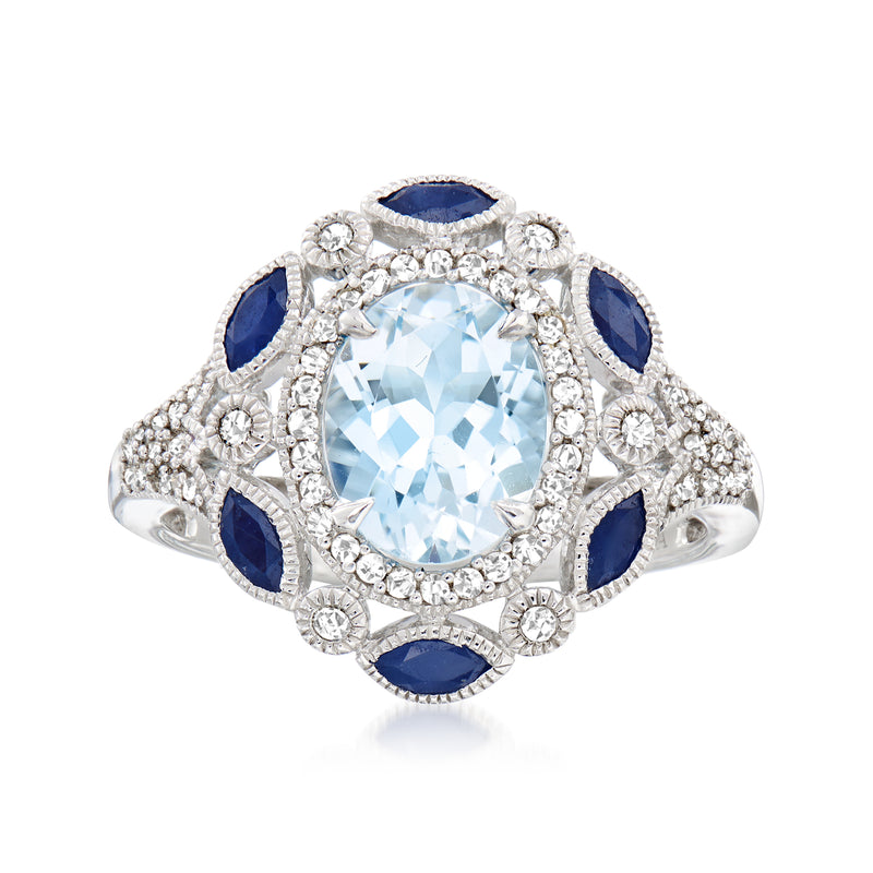 Aquamarine center gemstone ring in 14kt white gold with diamond accents and blue sapphire halos