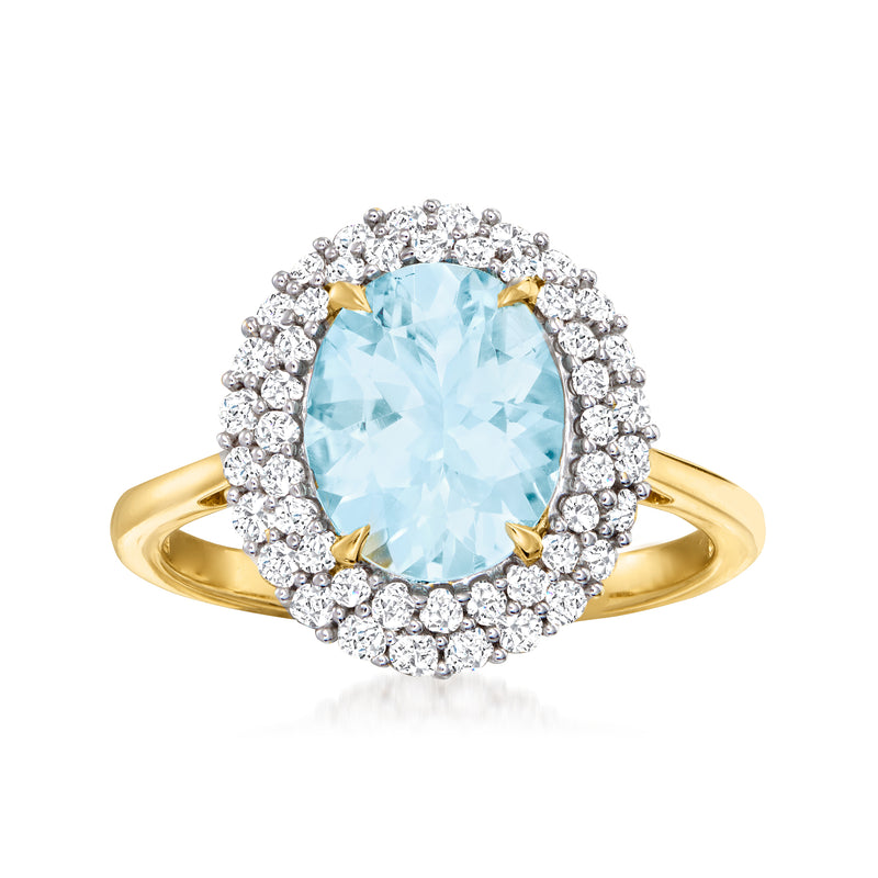 Oval aquamarine center with diamond halo ring in 14kt yellow gold